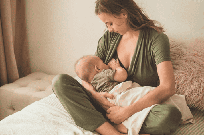 a mom breastfeeding her new baby